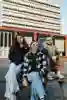 Three students sat on a picnic bench on campus at the University of Hull