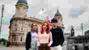 3 students stood in front of Hull Maritime Museum in Victoria Square, Hull City Centre