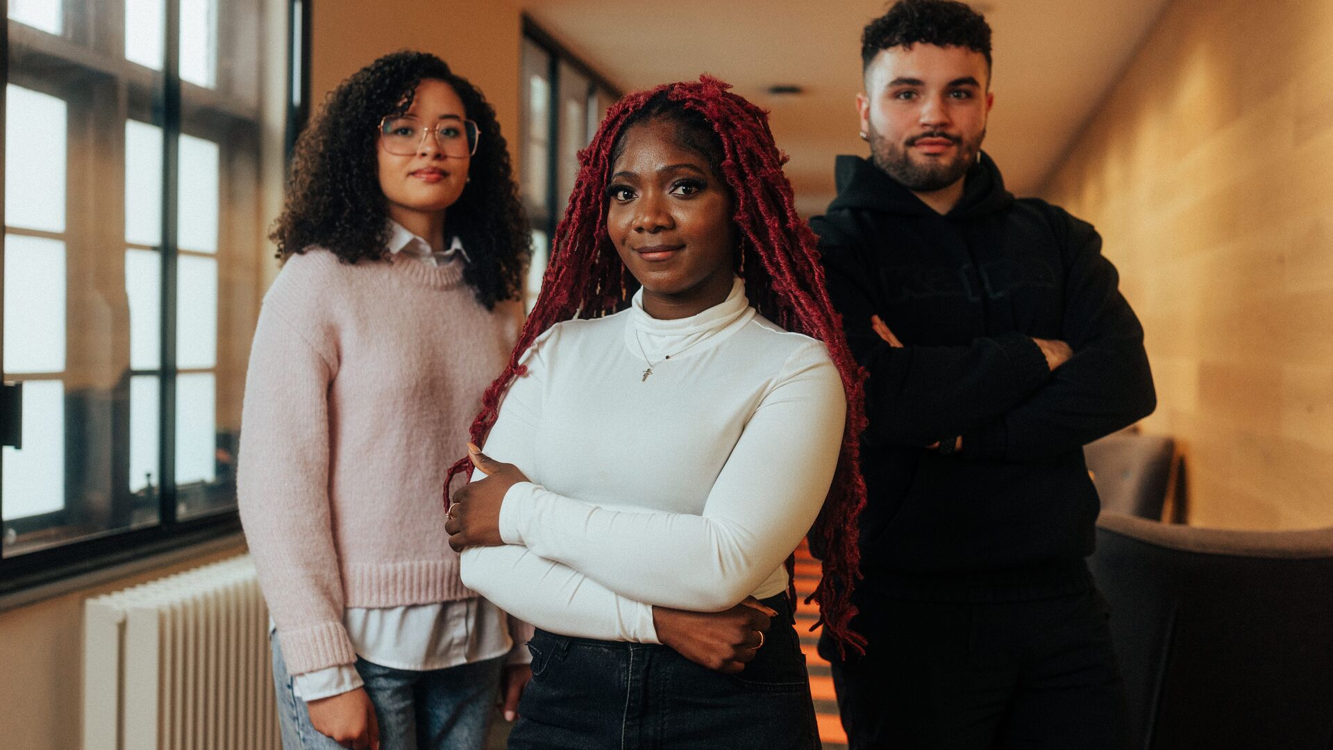 trio of students posing in corridor