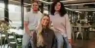 3 students sat on a table upstairs in the students' union