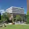 Library with student sitting on lawn in the foreground