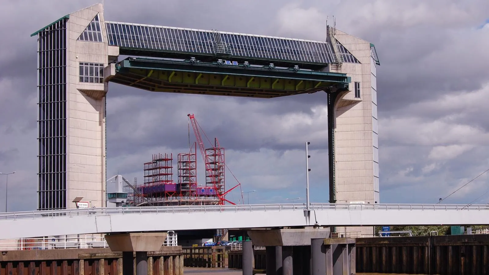 Tidal barrier in Hull with bridge in the foreground and a cloudy sky