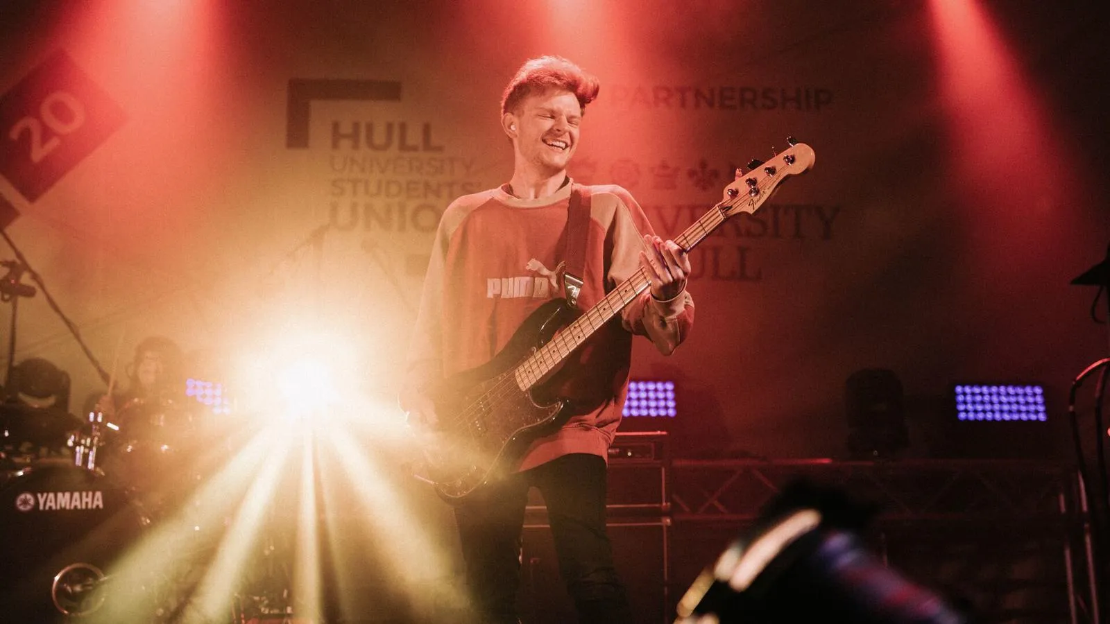 A performer playing guitar on stage