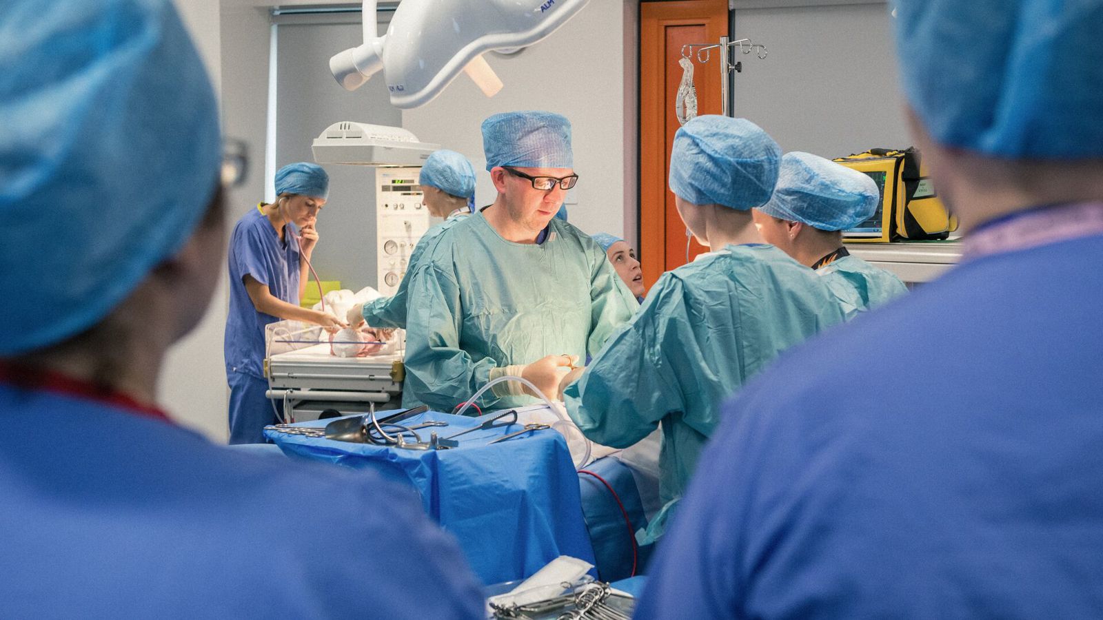 surgeons in scrubs carrying out an operation