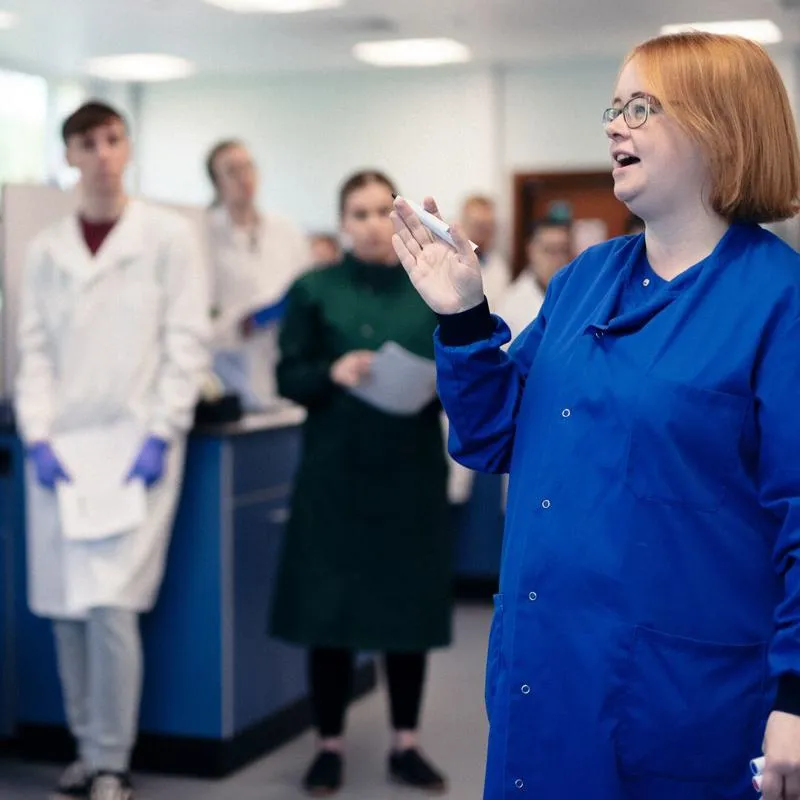 Teacher speaking to students in a biology lab