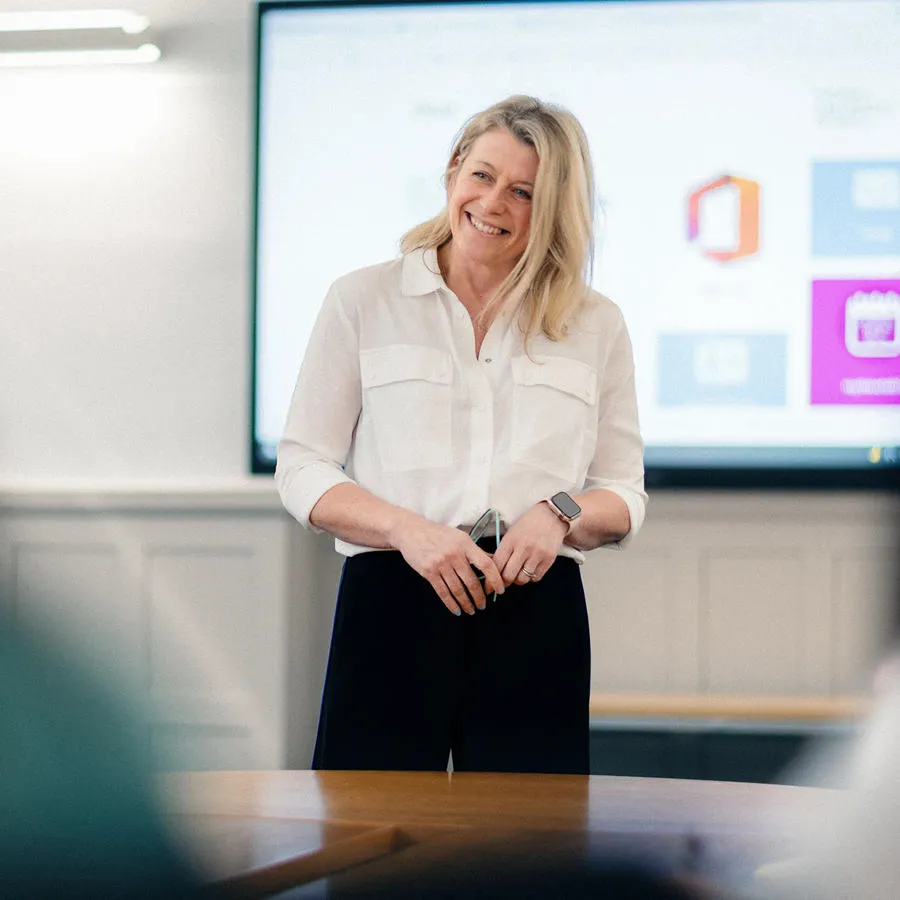 Woman standing in front of video display screen