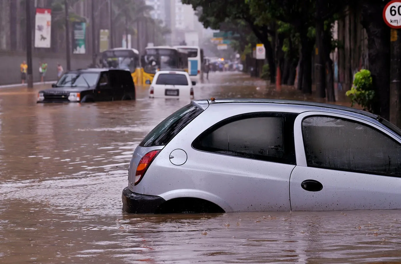 Abandoned cars in floodwater in an urban area