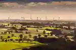 Countryside scene with windmills in the background