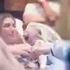 New born baby being handed to mother