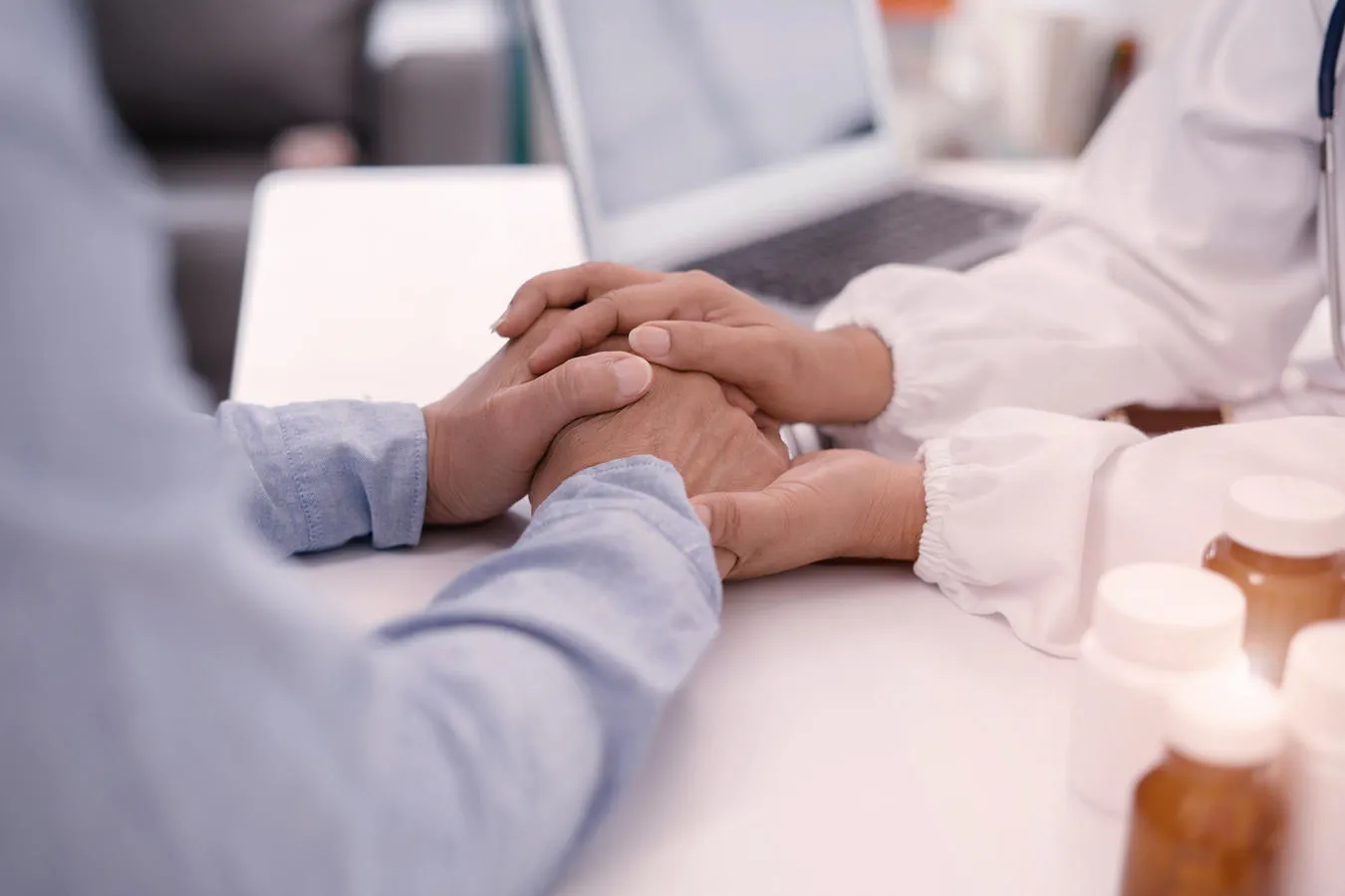 two people holding hands in support