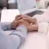 two people holding hands in support