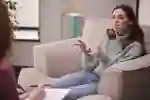 Young woman explaining something to someone in a comfortable setting
