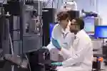 Two researchers on some machinery