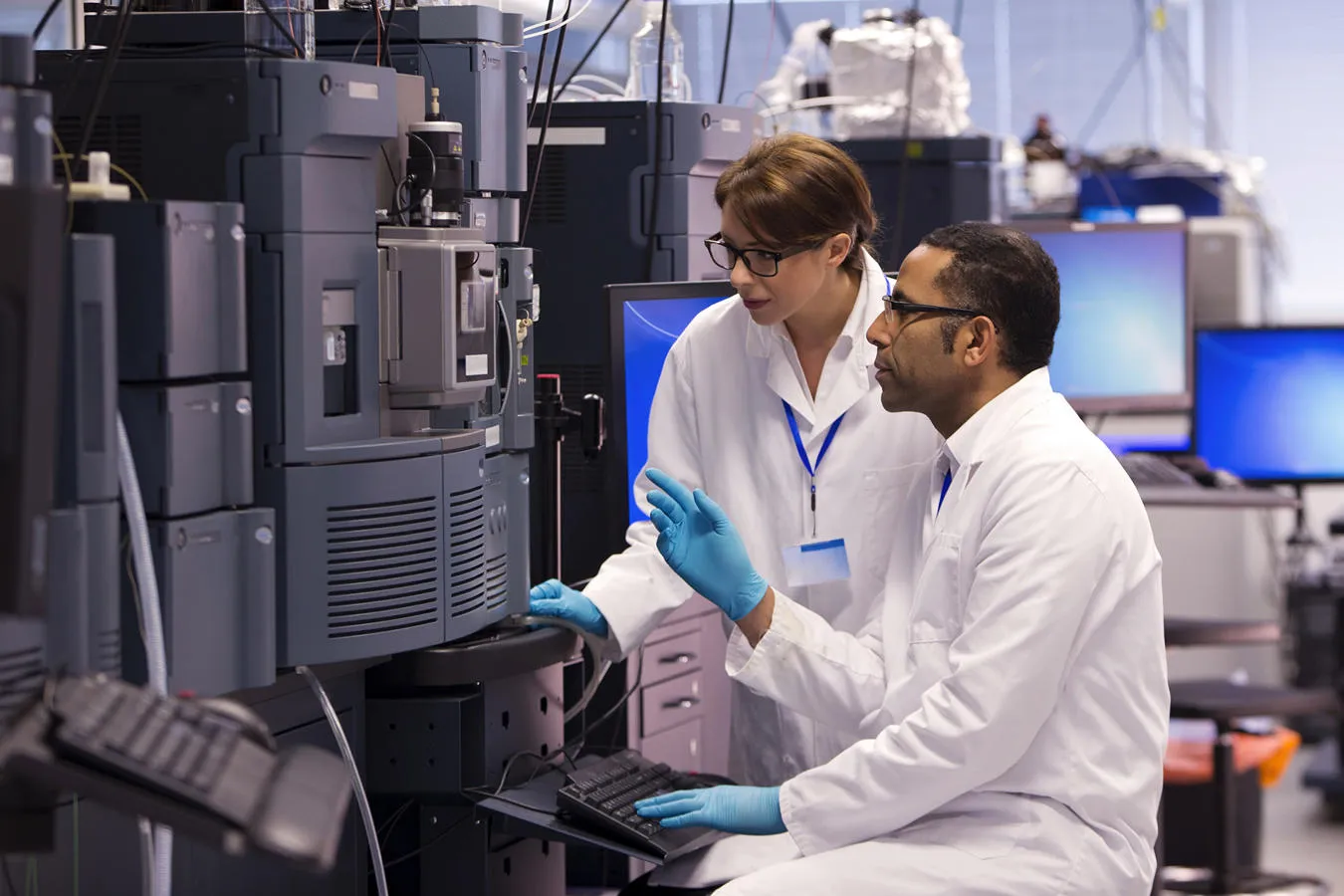 Two researchers on some machinery