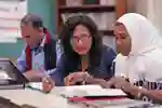 An educator works with students