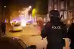 Policeperson with riot shield