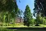 Venn building front lawn, trees and greenery on a sunny day