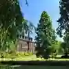Venn building front lawn, trees and greenery on a sunny day
