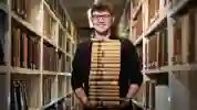 student holding books