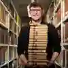 Student stood with a pile of books