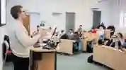 A lecturer speaking to a small room of people