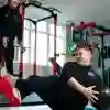 A student doing crunches whilst another monitors their progress.