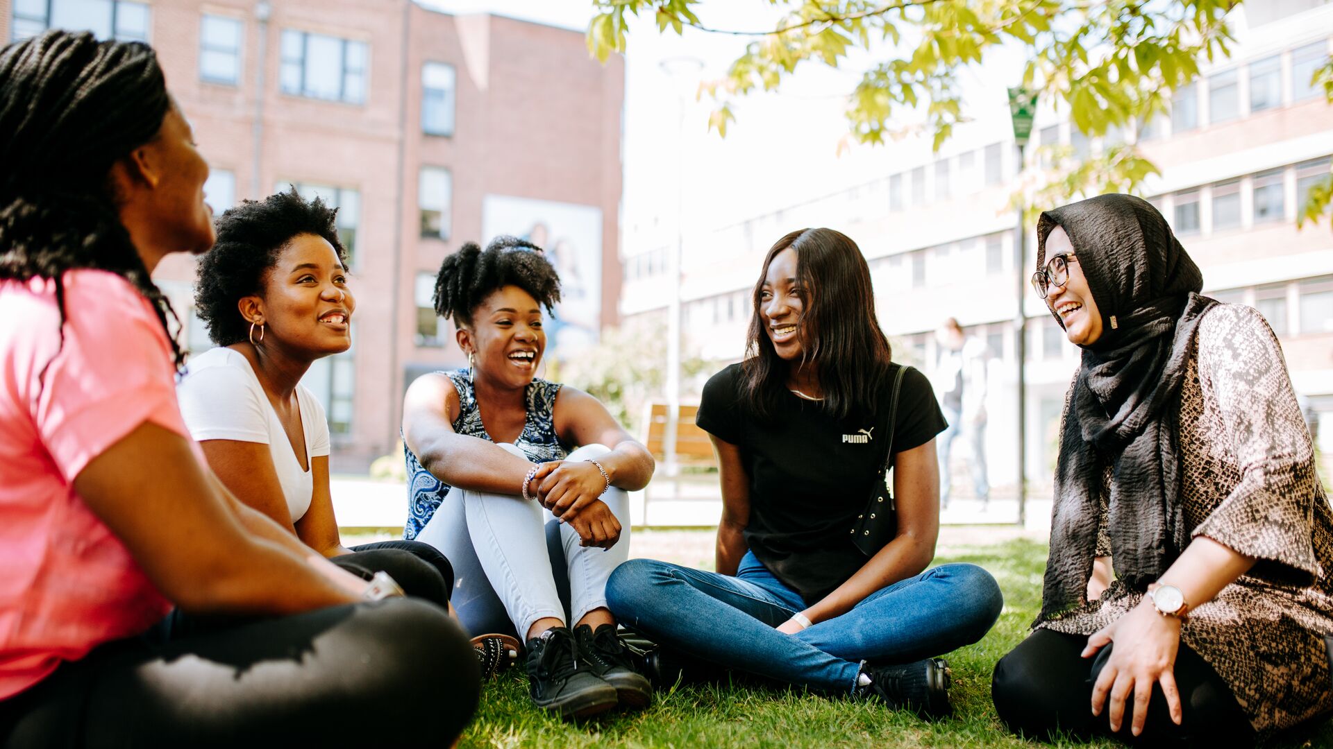 International Student Ambassadors Sat Chatting on Grass
