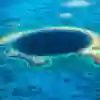 A large blue hole within a reef in the ocean
