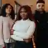 trio of students posing in corridor