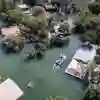 An aerial view of houses surrounded by flood water