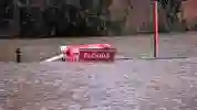 A floods expected sign submerged in water