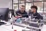Two men working with comuters and scientific equiptment