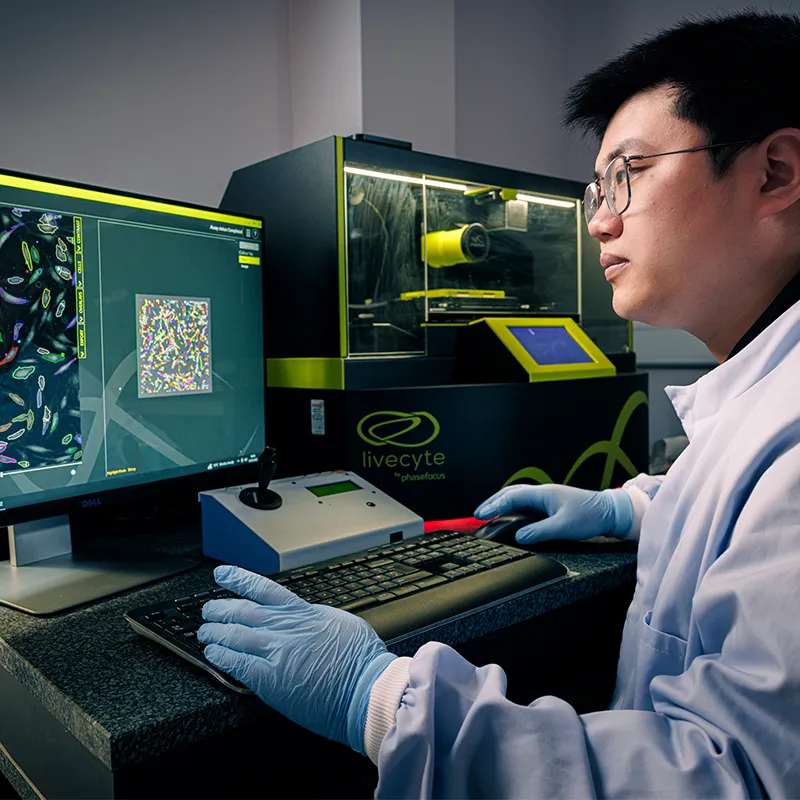 Man working using a computer with colourful display in the wound care lab