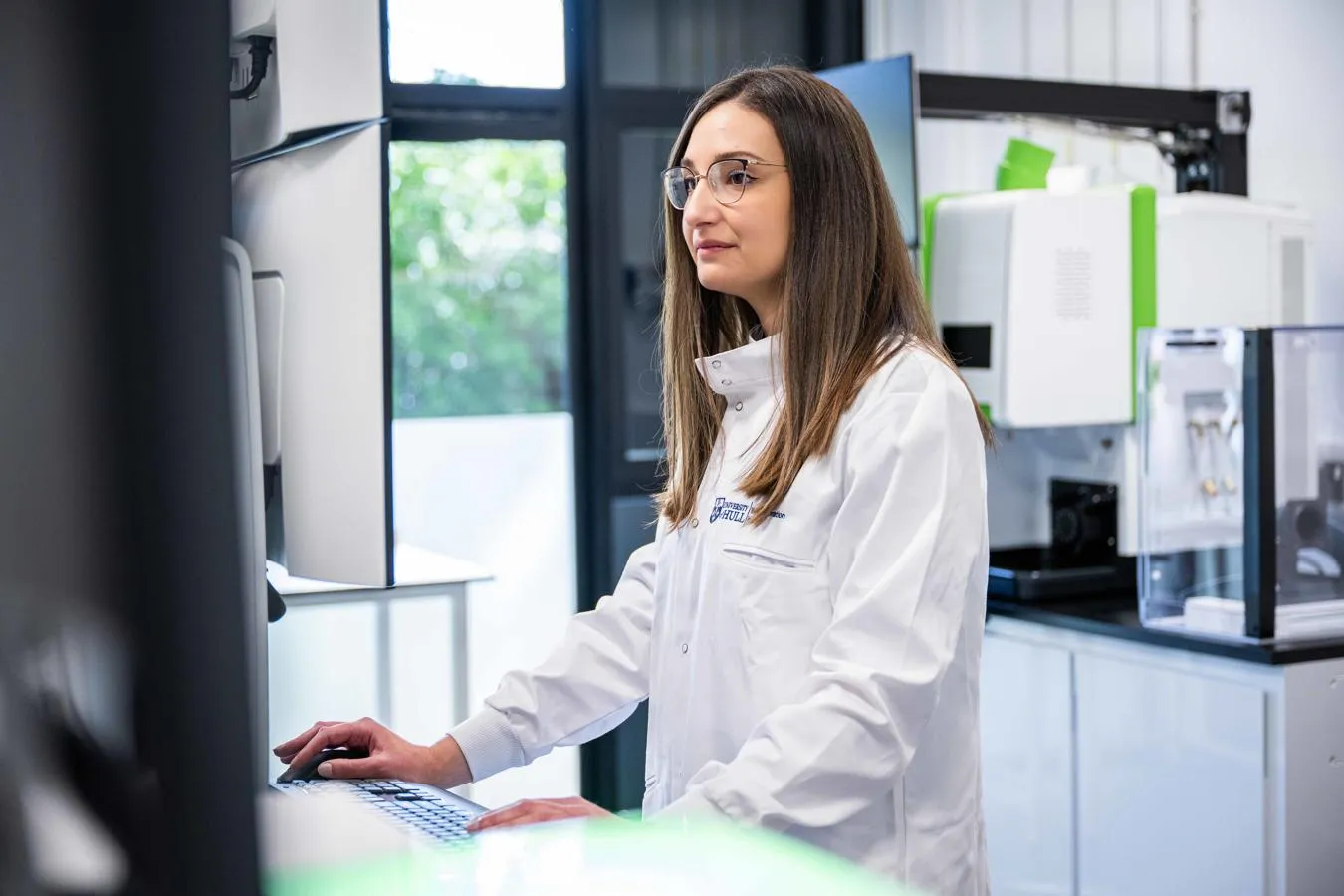 A researcher operates a terminal in a research laboratory