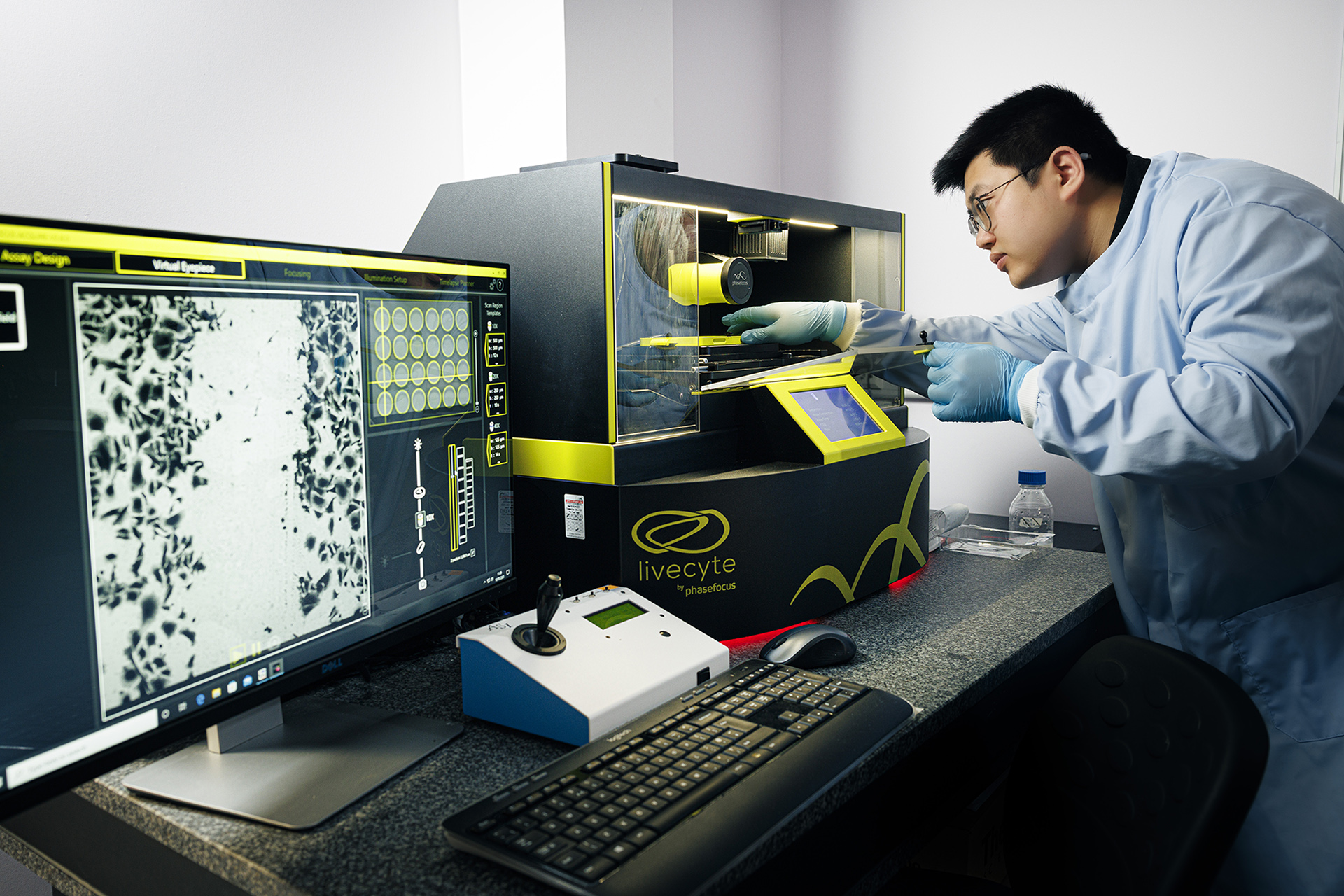 A Wound Innovation Institute researcher operates cell analysis equipment