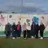 A group of students standing in front of a graffiti art project