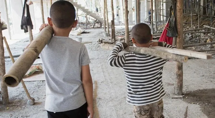 Two children working on a construction site