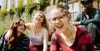 Students laughing sat on steps