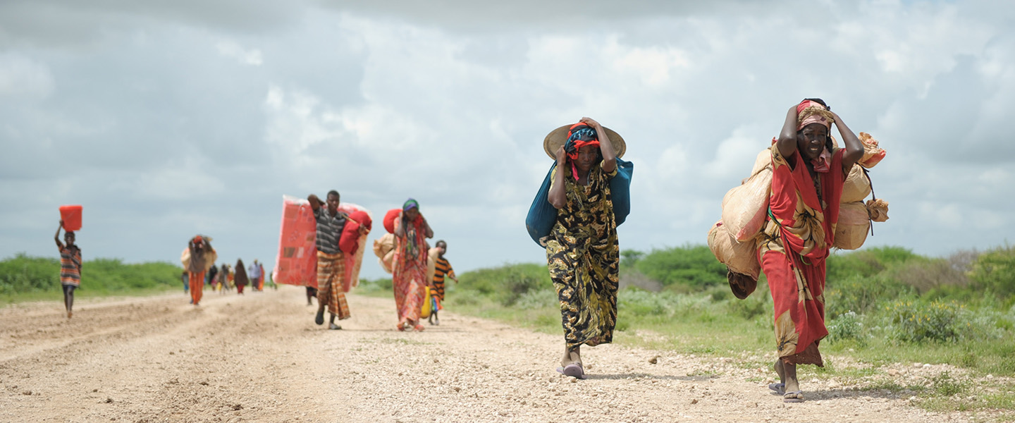 African people carrying their belonging displaced due to climate change