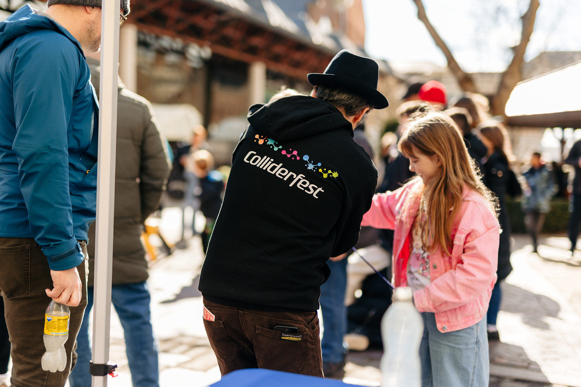 A Colliderfest science busker interacts with a young girl outside Hull Streetlife Museum