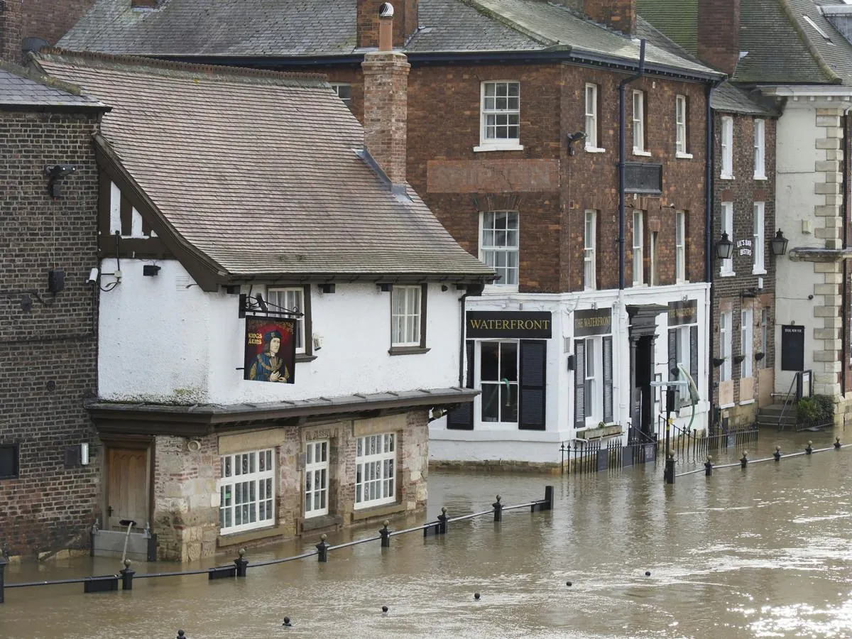 historic city street flooded with door protected by barrier 