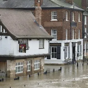 historic city street flooded with door protected by barrier