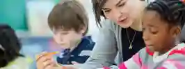 Female teacher with primary school children inthe  classroom