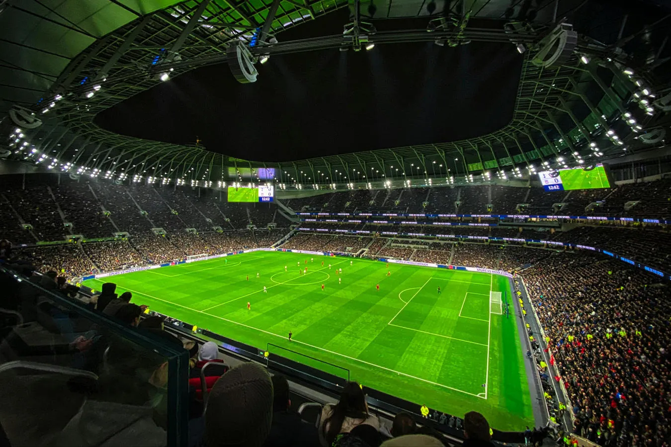 A floodlit football pitch during a match