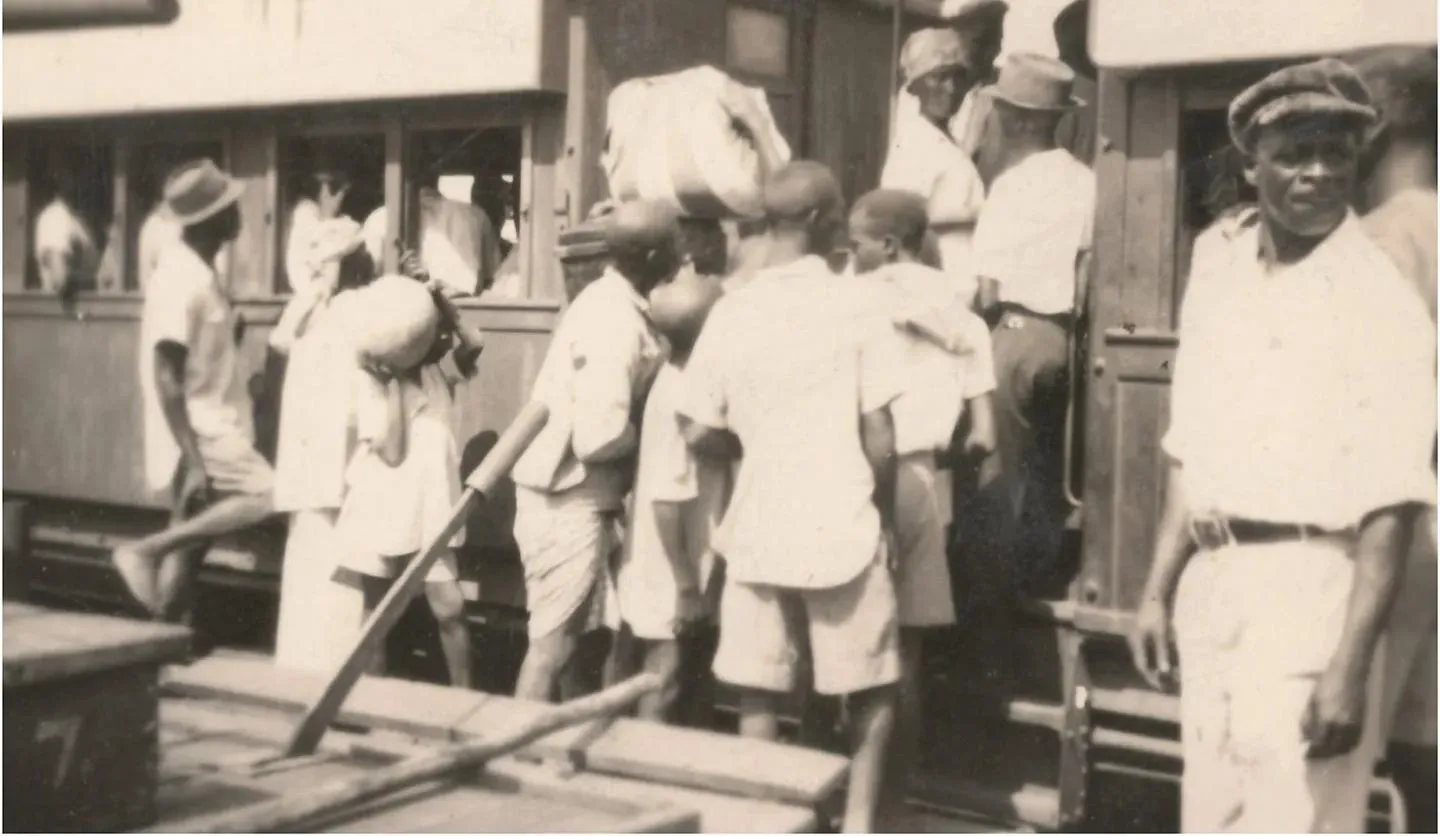 An early 20th Century photograph of people boarding a train at a station in Sierra Leone 