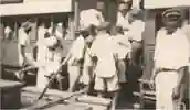 An early 20th Century photograph of people boarding a train at a station in Sierra Leone 