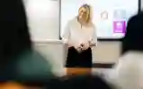 Person stood in front of smart board smiling