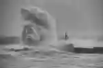 wave crashing into lighthouse