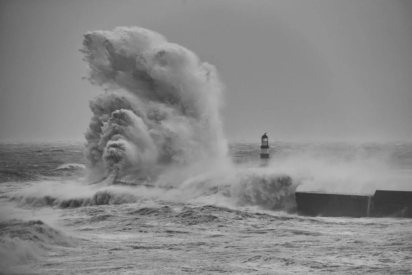 wave crashing into lighthouse