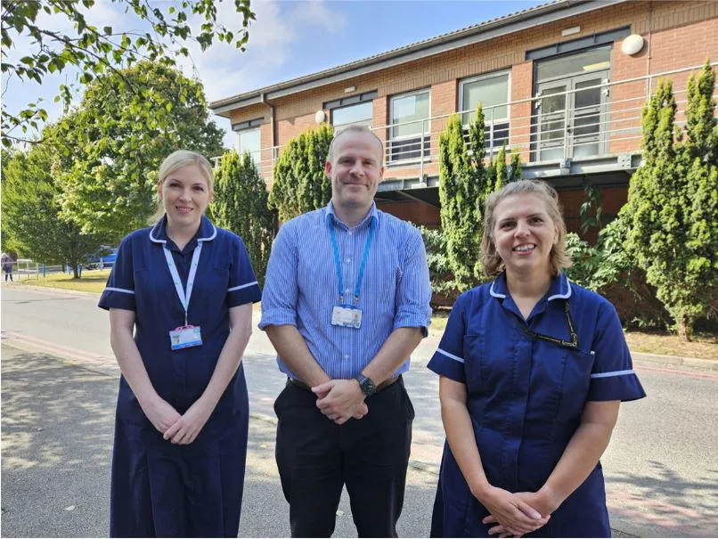 Professor Michael Crooks and respiratory nurses Kayleigh Brindle and Karen Watkins standing outside a hospital building